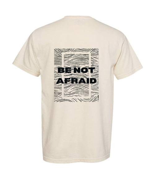 Beige t-shirt with 'BE NOT AFRAID' text on the back against a white background